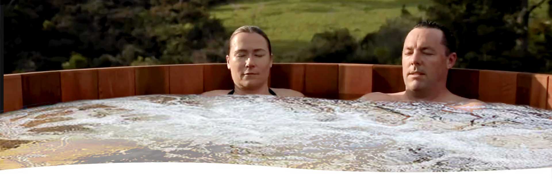 A couple relaxing in Cedar Hot Tub